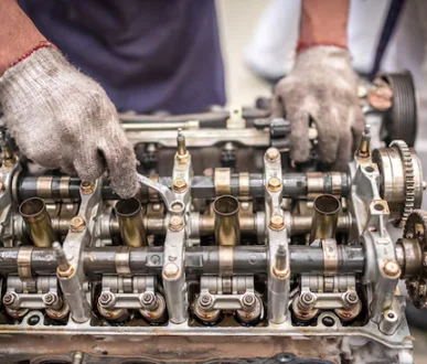 Technician performing cylinder head works.