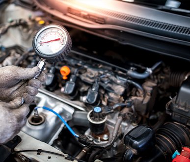 Mechanic performing engine heat checking & ensure optimal vehicle performance.